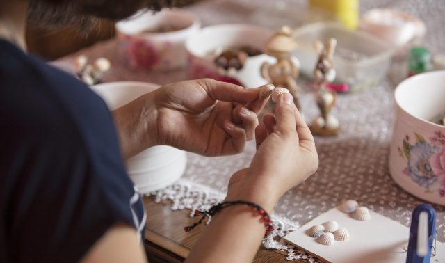 Master using small pins to make decorations. High quality photo